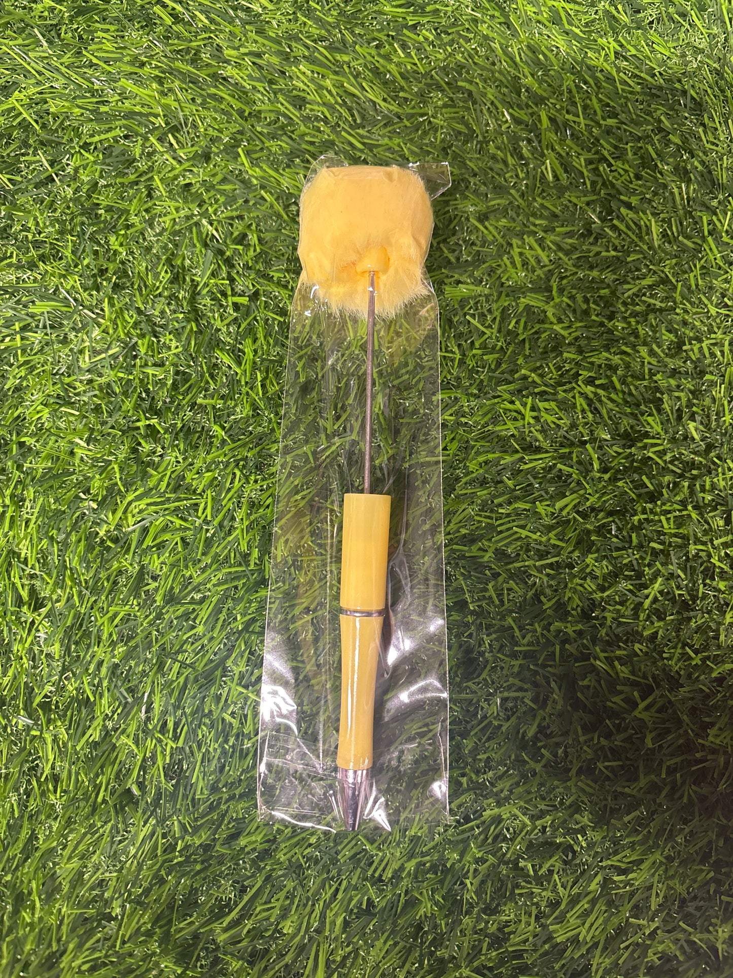 Yellow pompom pen